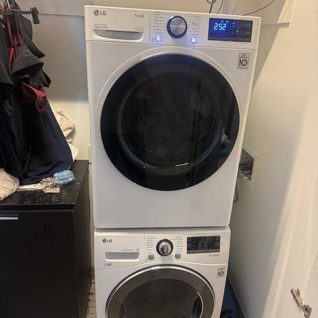 Stacked LG washer and heat pump dryer in a closet