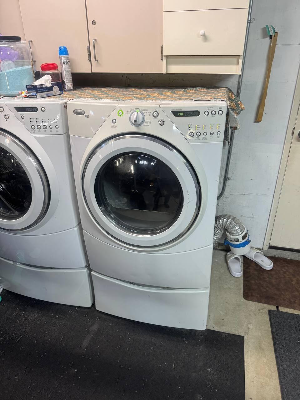 Washer and dryer in a garage with a flexible vent duct